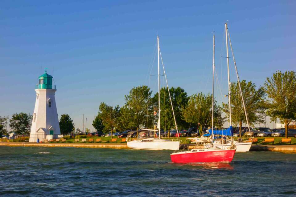 Sailboat at Port Dalhousie with the Inner Range Lighthouse in the background, St Catharines, Ontario.